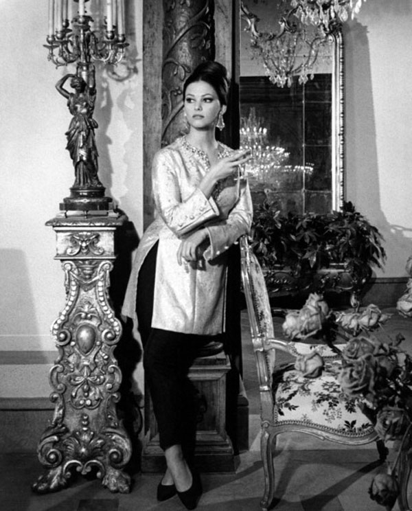 Claudia Cardinale posing in a scene dress